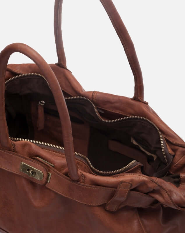 Close up view of an opened zippered Blossom Leather Kelly Bag in brown with two compartments
