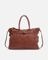 Detailed frontal view of a brown Blossom Leather Kelly Bag against a white backdrop